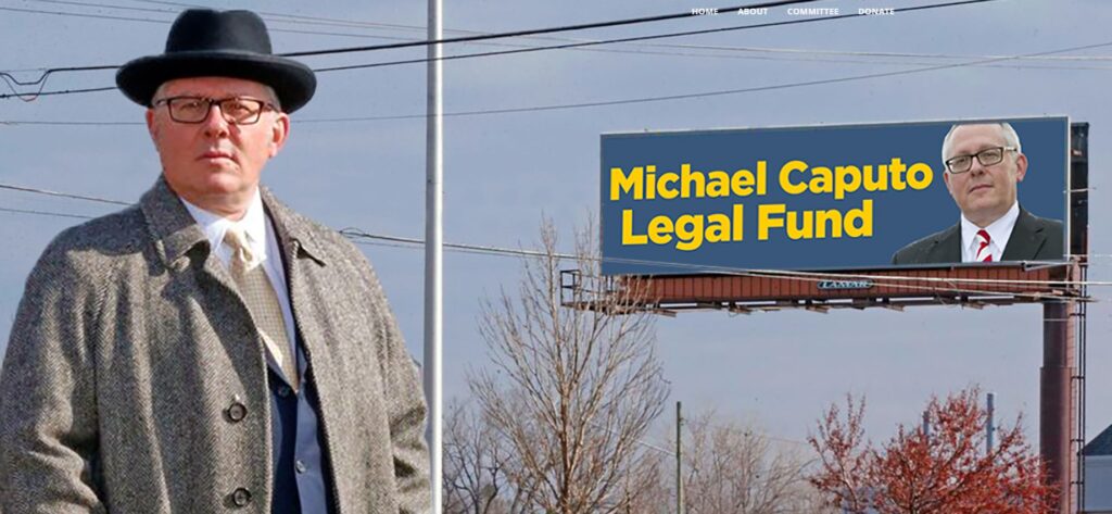 Michael Caputo stands near a billboard for his legal fund.